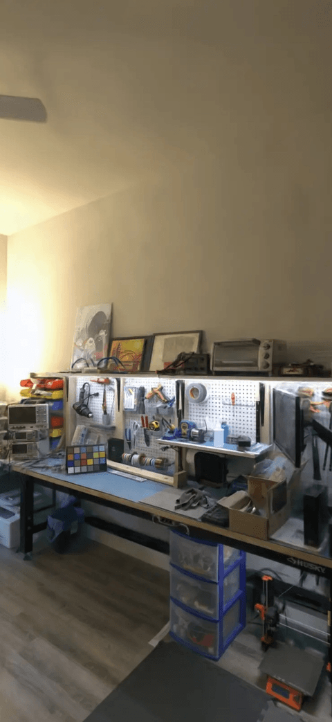 A Veylet 3D walkthrough of a public research capture: a workshop bench with tools, shelves and a 3D printer