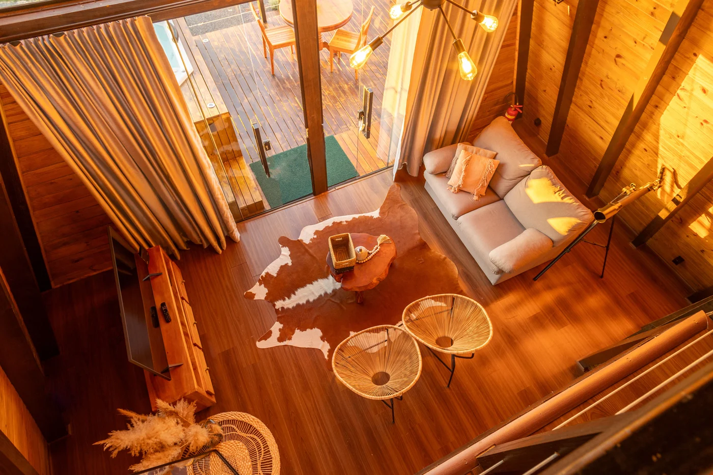 Loft overlook of the same sofa, rug, chairs and entrance below