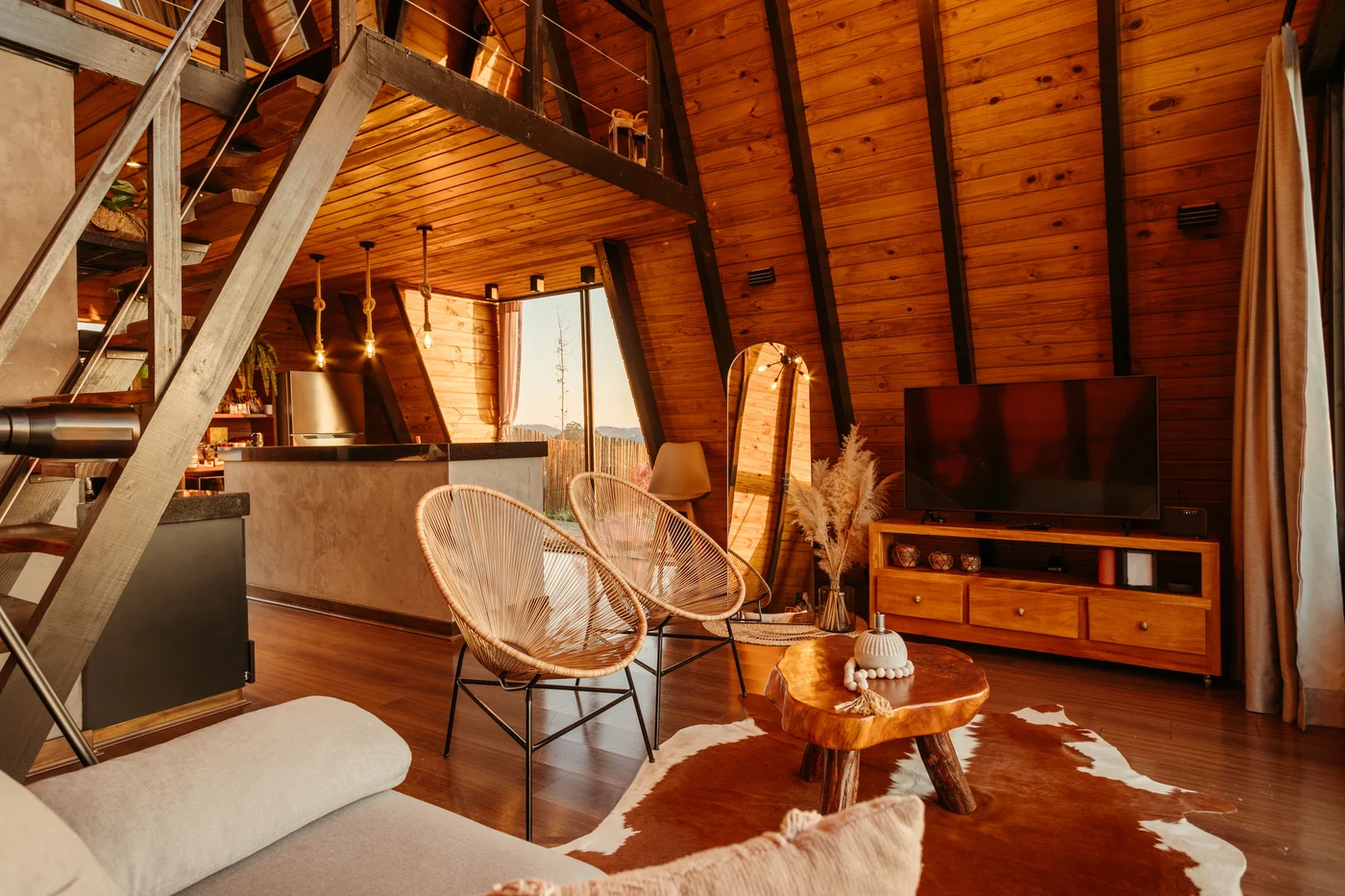 Timber staircase beside the open kitchen and living area